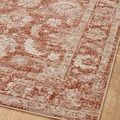Diagonal close-up showing rust and ivory traditional floral motifs with light beige edge