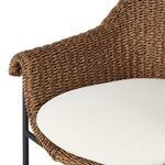 Close-up showing scalloped armrest curve and round white cushion corner