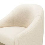 Detailed angle showing curved arm and back seam stitching of Levi Boucle Dining Chair in cream fabric