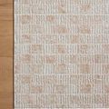 Close-up corner of Townes Beige Clay Rug on wooden floor showing pattern and neat binding