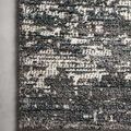 Detail of the rug’s edge on a light floor, highlighting low-pile edge contrast with raised pattern areas