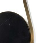 Close-up of black marble circular centerpiece and antique brass frame texture