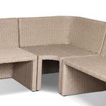 Close-up on corner junction without cushions revealing woven rattan seating surface