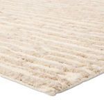 Close-up of the rug showing thick, textured wool and cotton fibers with striped detail