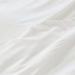 Close-up of soft white bamboo fabric with smooth texture and subtle sheen