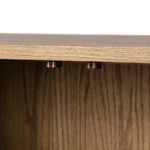 Close-up perspective of the oak wood rounded corner and base leg with floor protector