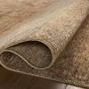 Rolled corner of Heritage Natural Mist rug highlighting pile thickness and color variation on wooden floor