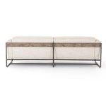 Close-up detail of black metal sofa base and taupe fabric leg angle