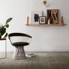 Rug in room setting with chair, table, and potted plant near window with natural light