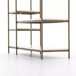Close-up angle underneath showing the marble shelves and brass frame extending outward