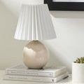 Ferez lamp styled on white desk stacked on books with succulent plant and notebook nearby