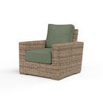 Outdoor Havana Club Chair in aged tobacco wicker with green cushions and ample square frame