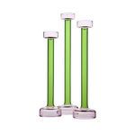 Set of three green and pink glass candle holders of varying heights, side by side on white background