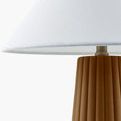 Side view close-up of white linen lampshade edge and lamp neck fitting