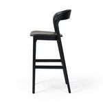Side profile focusing on backrest curve and leather seating