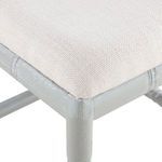 Close-up of cream upholstered seat cushion with subtle woven texture on grey stool frame