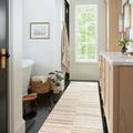 Long runner rug version of Chris Ivory Clay in narrow hallway with natural wood cabinets and marble countertop