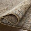 Close-up of the Heritage Spa Earth Rug rolled to highlight its textured variable-pile and color shading