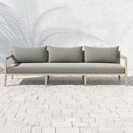 Outdoor front view on stone patio with soft shadow under sofa and visible sunlight
