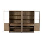 Low angle close-up of bottom corner foot with metal hinges on drifted oak cabinet doors