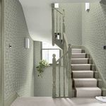 Hopwood Cottage Sage wallpaper applied on staircase walls with soft lighting and pale carpet