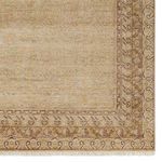 Repeat detailed view of rug border with traditional motifs in soft gold and brown