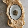 Mame Dessert Plate displayed on crumpled brown paper with roasted capers in the center