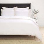 Twin-sized Langston Bamboo Sateen Duvet Set in natural sand color with smooth, soft texture on black bed frame