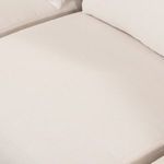 close-up of sofa leg showing rounded wooden frame and support structure