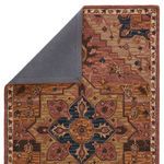 Back view of rug with corner folded revealing solid gray non-slip backing