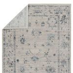 Rug folded back to reveal underside with muted pattern and weave detail