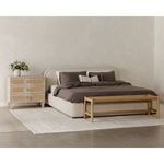 Wide angle of Colin king bed with dark bedding, light-colored dresser and wooden bench in modern bedroom