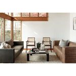 Modern living space with Takashi chairs positioned between leather and fabric sofas