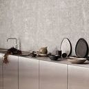 Kitchen scene featuring Mame Dip Bowl and other serveware on sleek modern counter against textured wall