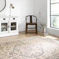 Teagan rug in a bright room with white walls, wooden chair, and white cabinet by a window.