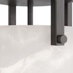 Close-up of alabaster shade surface showing subtle marbling and iron frame screw detail