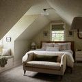 Louisa Lagoon Ivory Rug layered in a cozy attic bedroom with angled ceiling and seating bench