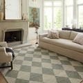 Francis Spa granite rug styled in a living room with beige sofa and fireplace, showing full rug in room context