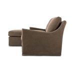 Side profile of sectional showing rounded back with flared arm and cushions from right side
