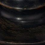 Close-up texture of the dark turned mango wood base showing grain and finish details