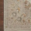 Close-up of corner detail on ivory and beige traditional rug with floral patterns on wooden floor