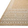 Close-up angled view of rug corner showing detailed white geometric woven border