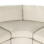 Top-down view of sectional’s corner, showing curved back cushions and connecting design