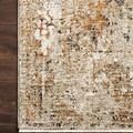 Close-up showing Theia Taupe / Gold rug's textured rayon and polyester pile with refined fringe border on dark wood floor
