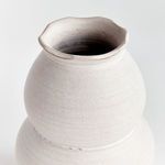 Close-up on the top portion and wavy rim highlighting the textured ridges of the vase