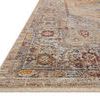 Low-angle close-up of Sorrento rug showing detailed faded pattern and fringed edge on a wood floor