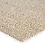 Close-up of blended wool and jute fiber texture in natural beige gray tones