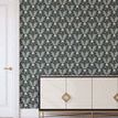 Wallpaper applied on a full wall behind a mid-century modern cream and gold sideboard with white trim and door