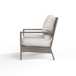 Side profile highlighting thick white cushions and angled aluminum frame of Laguna Club Chair
