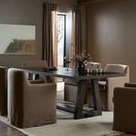 Silverton Dining Table in room context featuring carpeted floor, wall art, and draped window